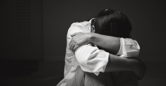 young, depressed woman holding her head